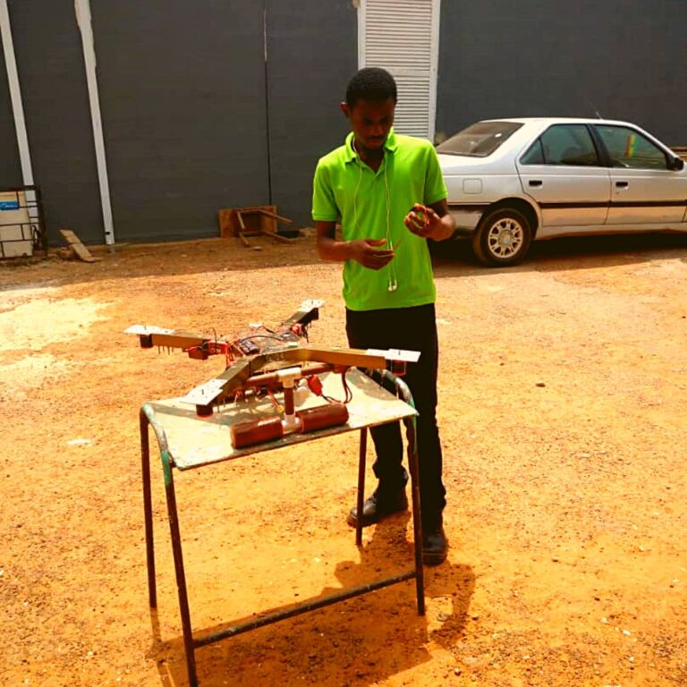 Peter standing in front of a quadcopter - his final year project at the university