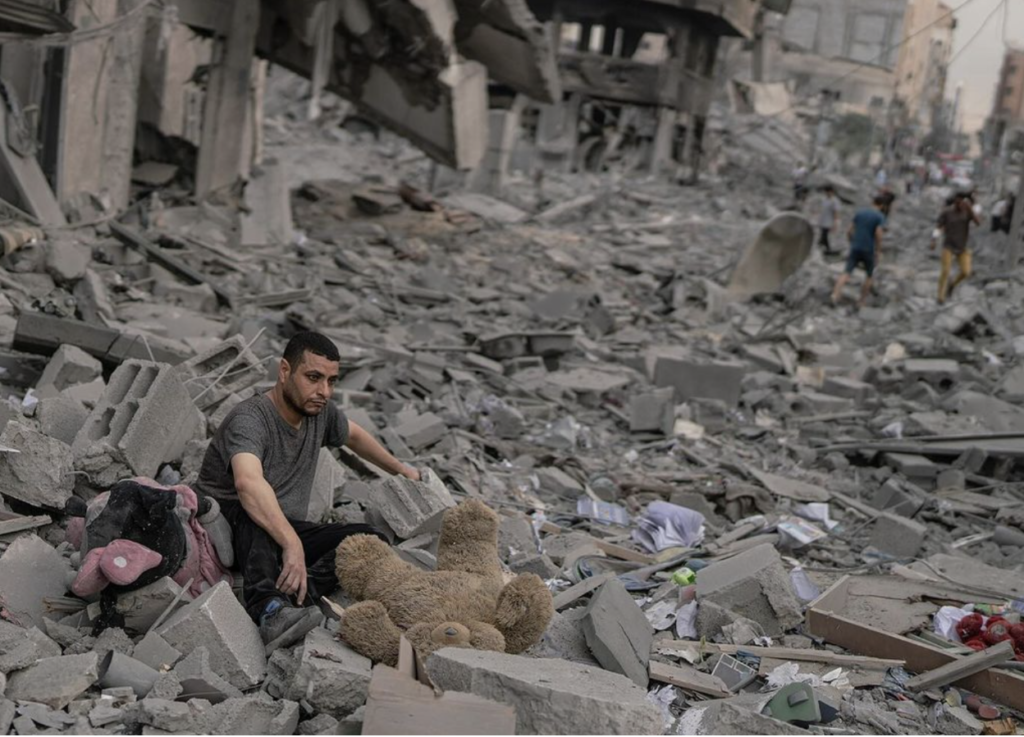 gaza man sitting in rubble