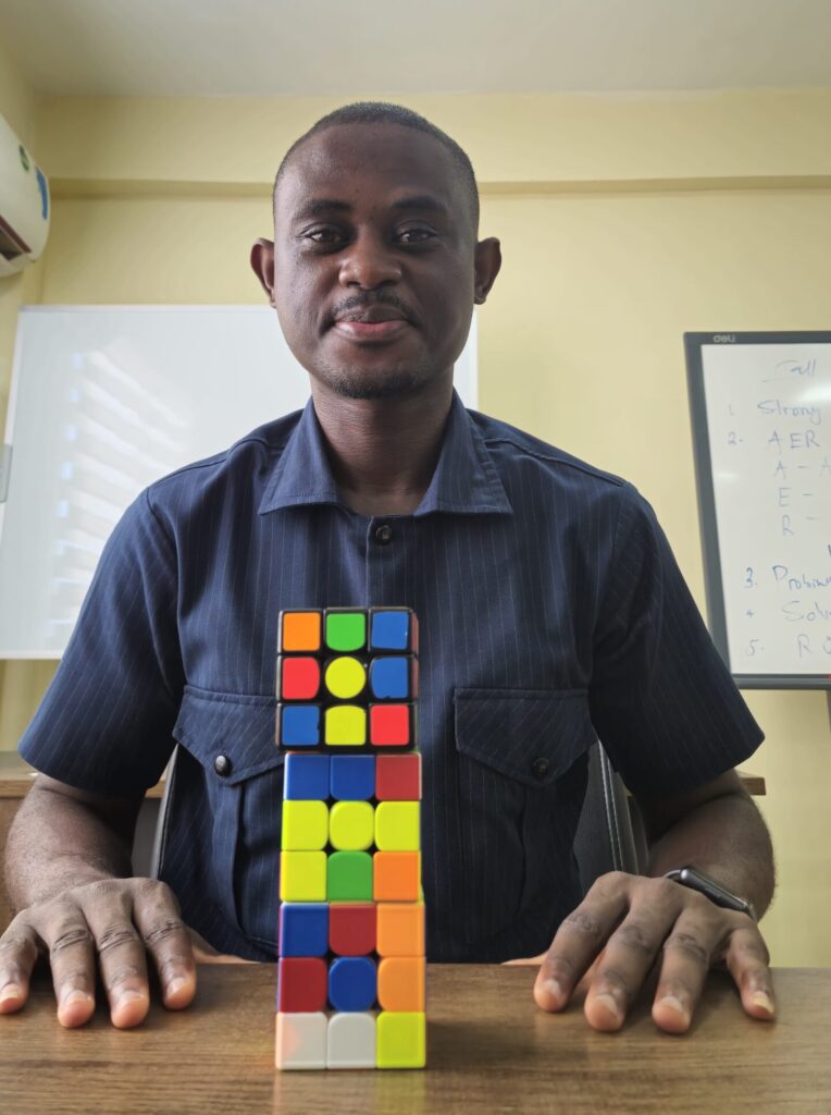 Peter posing in front of his Rubik's Cube Tower